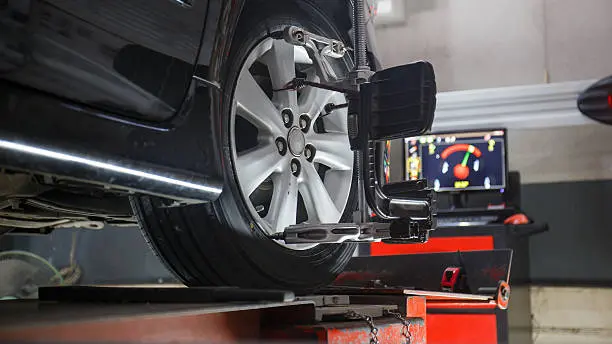 A car is being worked on by a mechanic.